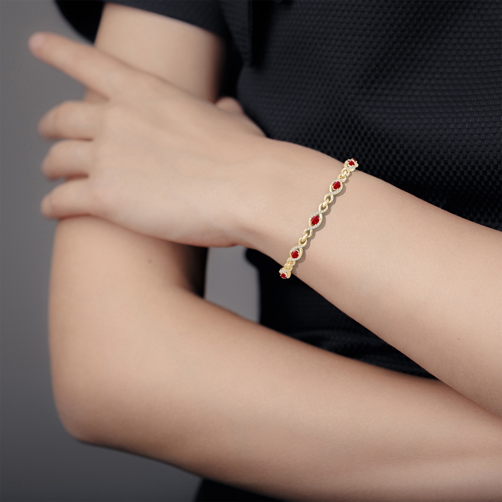 4x3mm AAA Oval Ruby Infinity Link Bracelet with Diamonds in Yellow Gold - body_hand