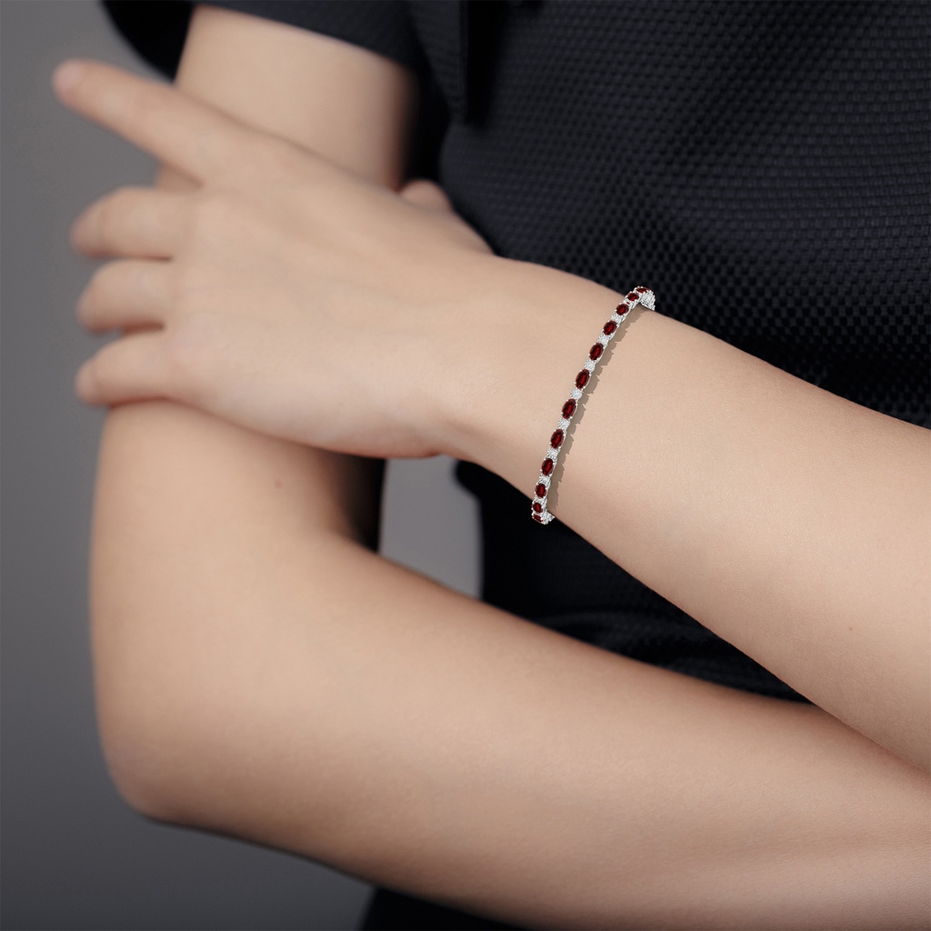 5x3mm AAAA Oval Garnet Tennis Bracelet with Gypsy Diamonds in White Gold - body_hand