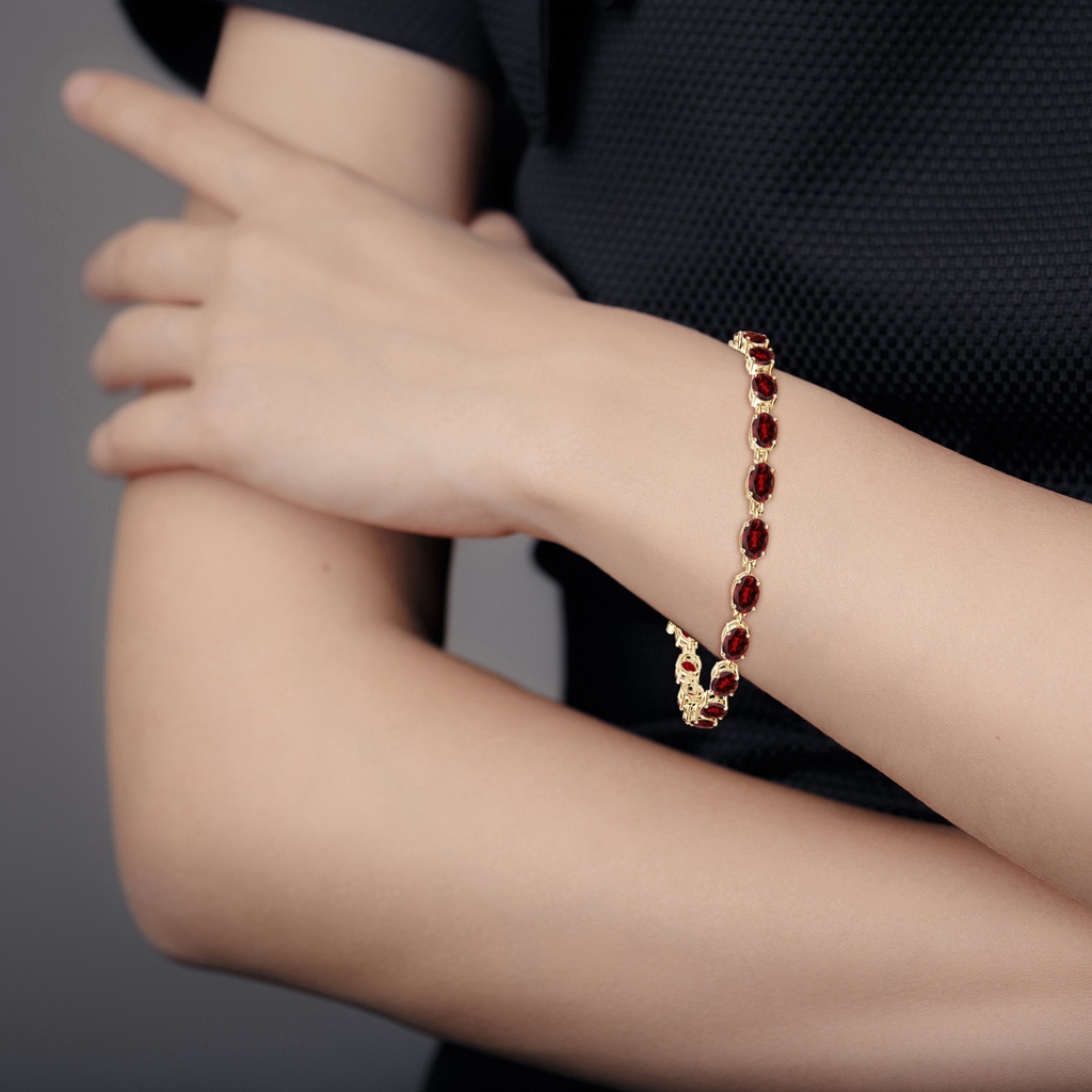6x4mm AAAA Classic Oval Garnet Tennis Bracelet in Yellow Gold - body_bra