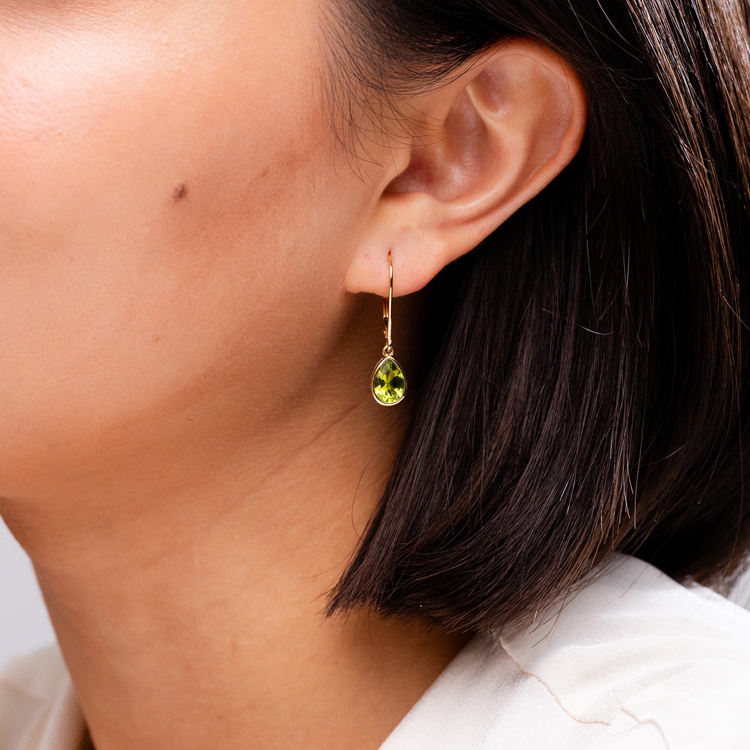 Bezel-Set Pear Peridot Leverback Drop Earrings | Angara