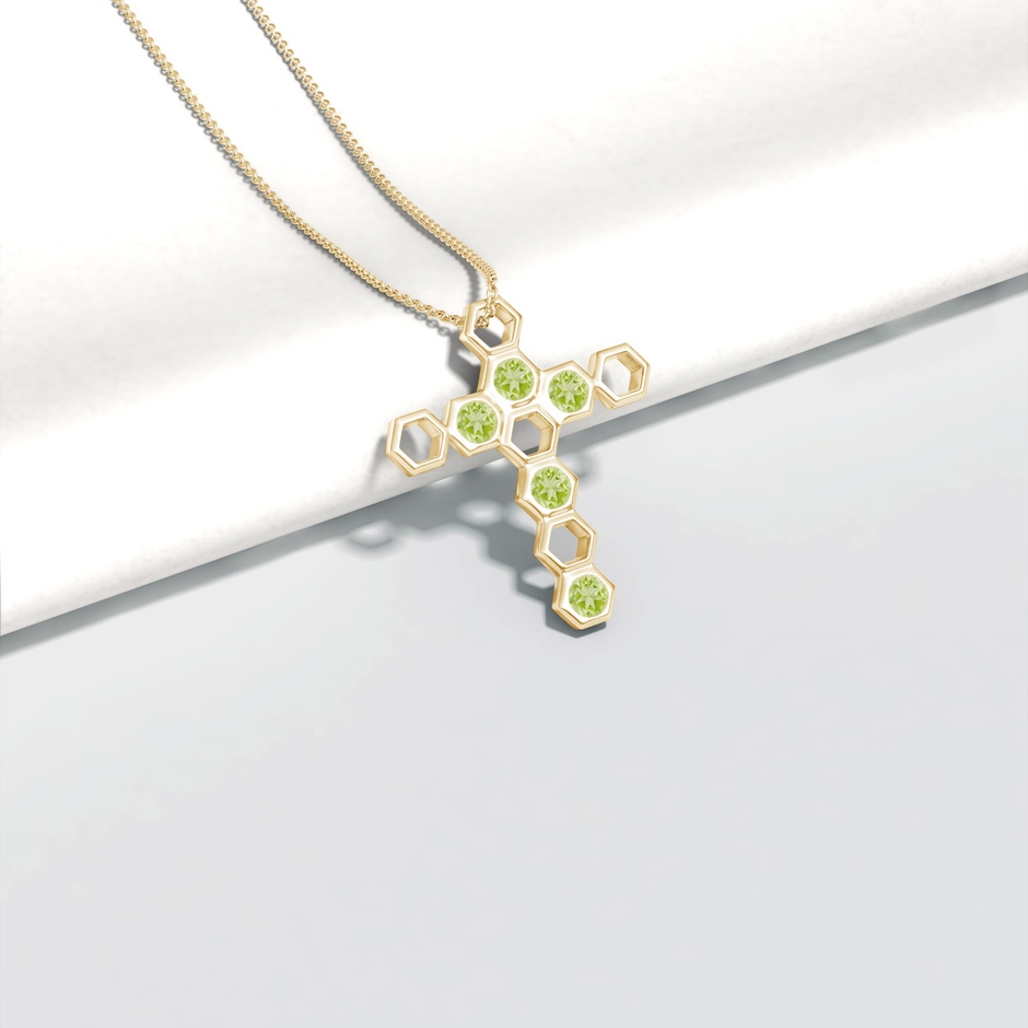 3mm AAA Natori x Angara Hexagonal Alternate Peridot Cross Pendant in Yellow Gold lifestyle