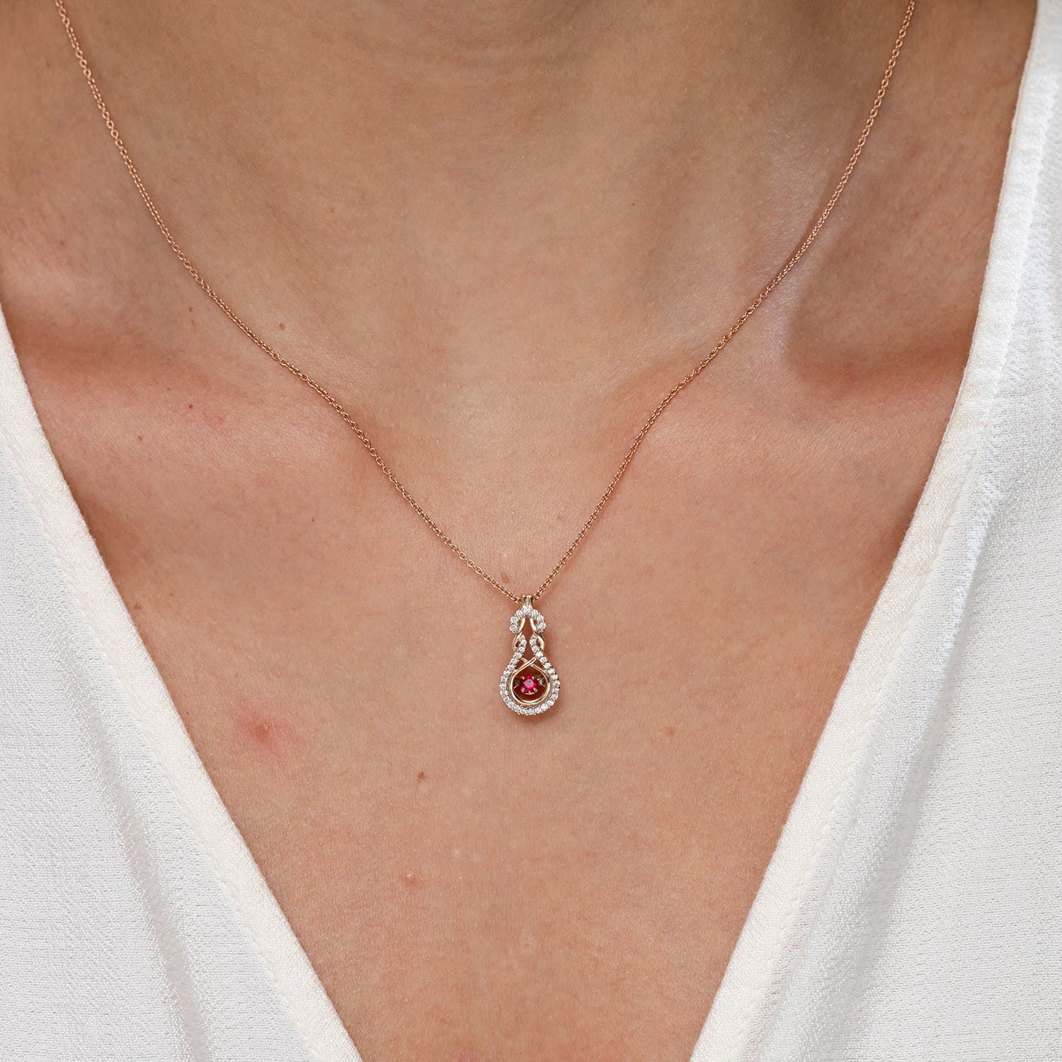 Dancing Ruby Infinity Knot Pendant with Diamonds