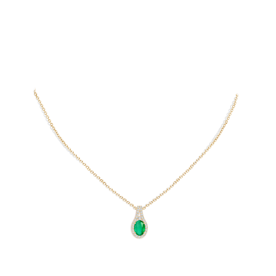 7x5mm A Classic Emerald and Diamond Halo Pendant in Yellow Gold pen