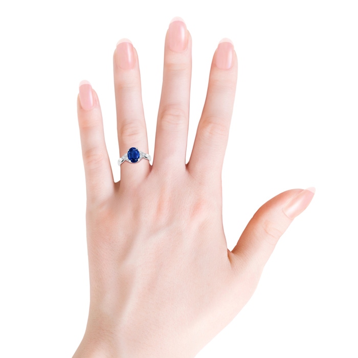 8x6mm AAA Oval Blue Sapphire Cocktail Ring With Trio Diamond Accents in White Gold body-hand