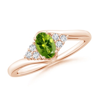 6x4mm AAAA Oval Peridot Bypass Ring with Trio Diamond Accents in 9K Rose Gold
