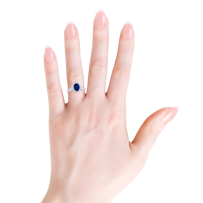 8x6mm AAAA Classic Oval Blue Sapphire Halo Ring with Diamond Accents in White Gold Body-Hand