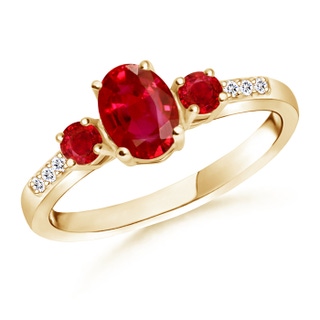 7x5mm AAA Oval Ruby Three Stone Ring with Diamond Accents in Yellow Gold
