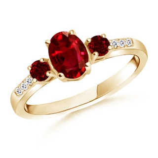 7x5mm AAAA Oval Ruby Three Stone Ring with Diamond Accents in Yellow Gold