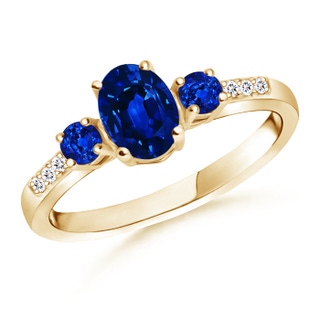 7x5mm AAAA Oval Sapphire Three Stone Ring with Diamond Accents in Yellow Gold
