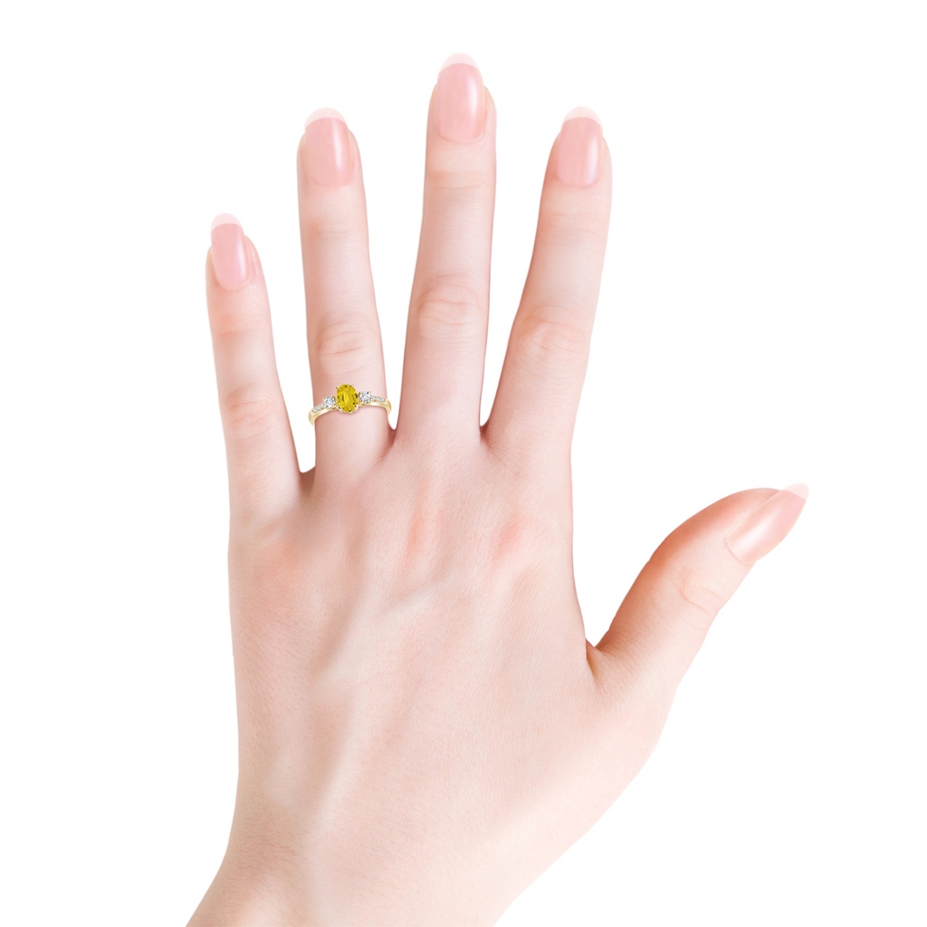 7x5mm AAA Classic Oval Yellow Sapphire & Round Diamond Three Stone Ring in Yellow Gold Body-Hand