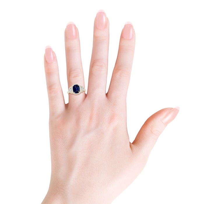 8x6mm AAA Cushion Blue Sapphire and Half Moon Diamond Halo Ring in Yellow Gold hand