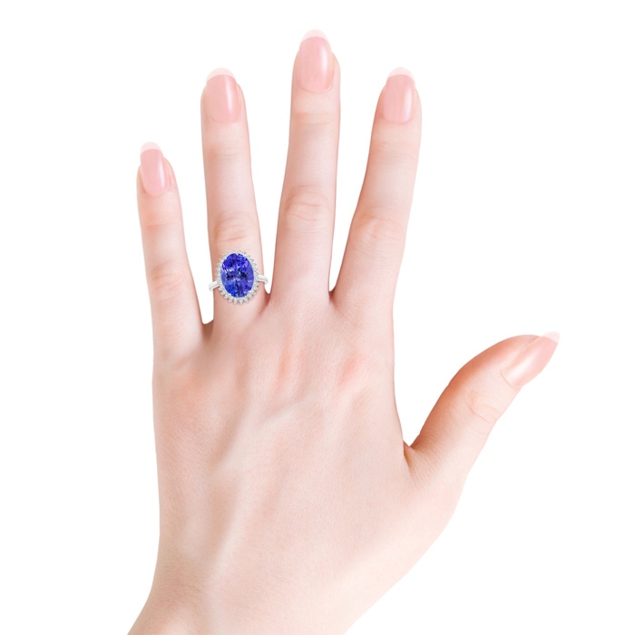 14x10mm AAA Classic Oval Tanzanite Floral Halo Ring in White Gold Body-Hand