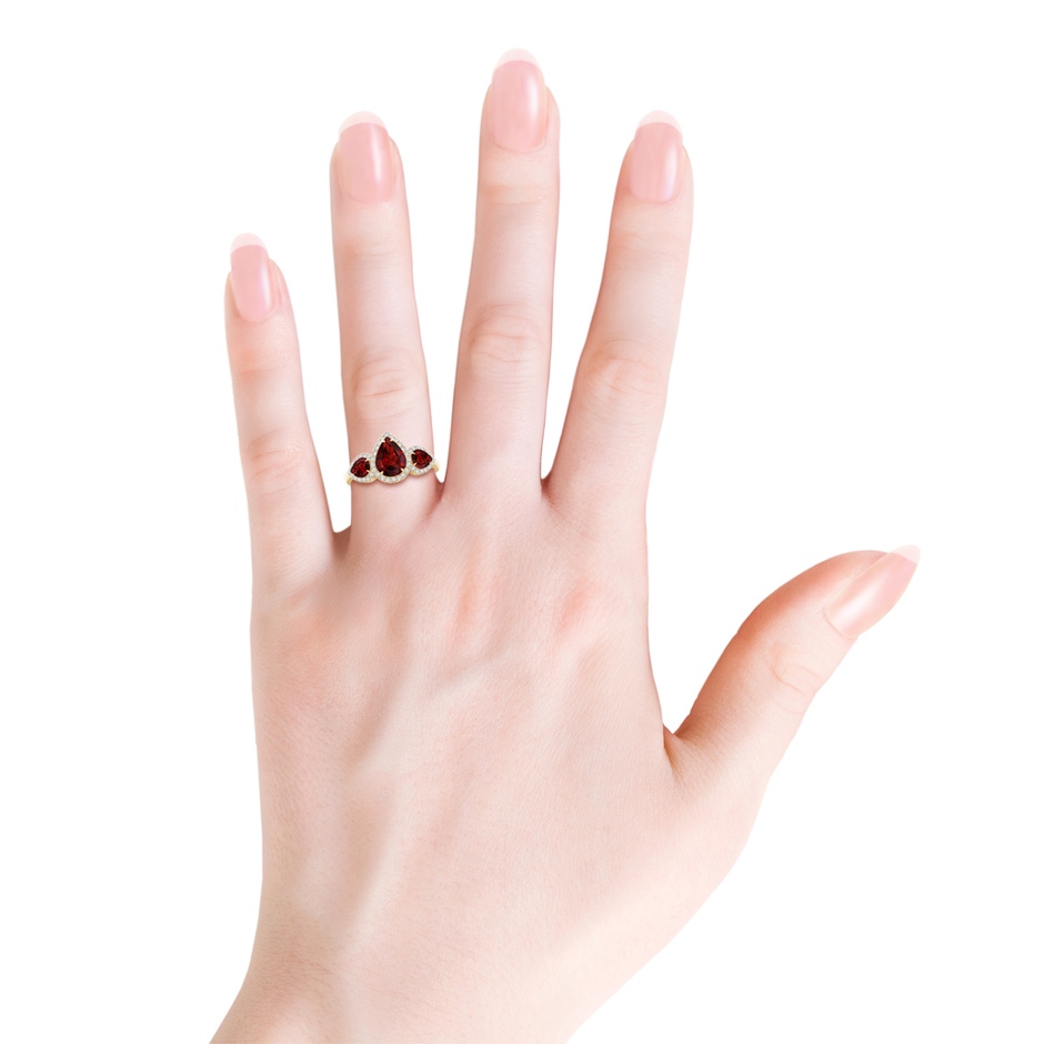 8x6mm AAAA Claw-Set Pear Garnet Three Stone Ring with Diamond Halo in Yellow Gold product image