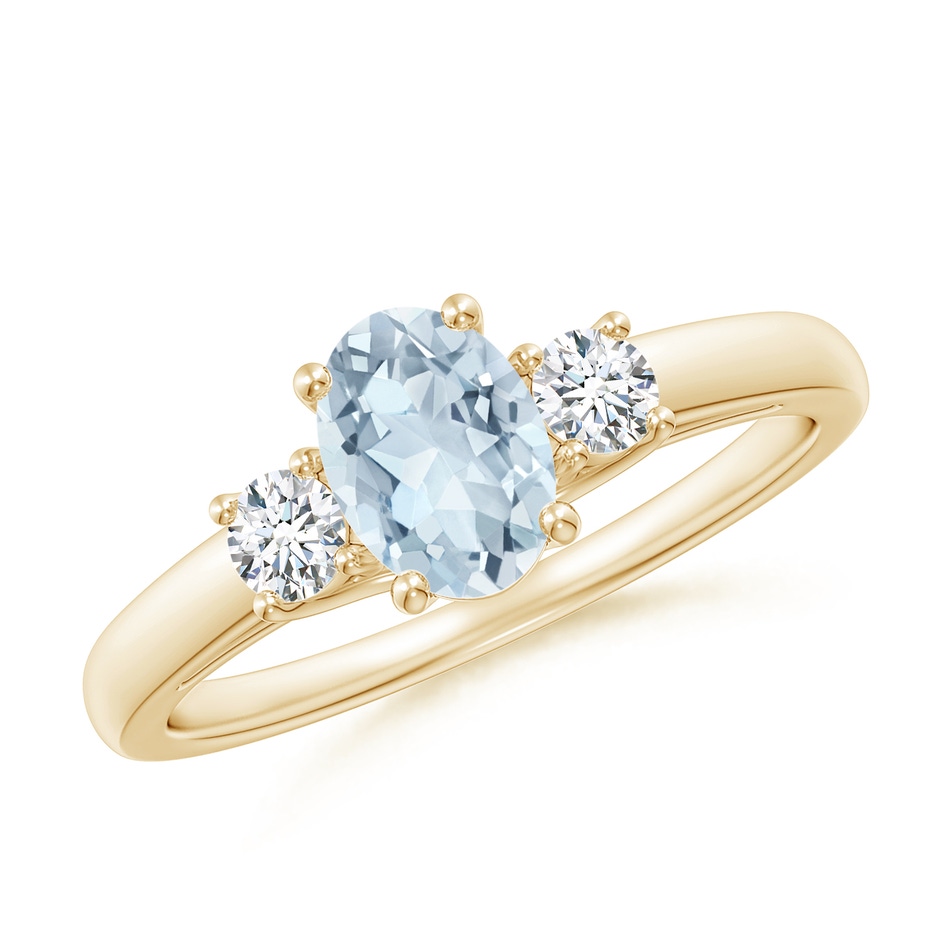 7x5mm A Oval Aquamarine and Round Diamond Three Stone Ring in Yellow Gold 