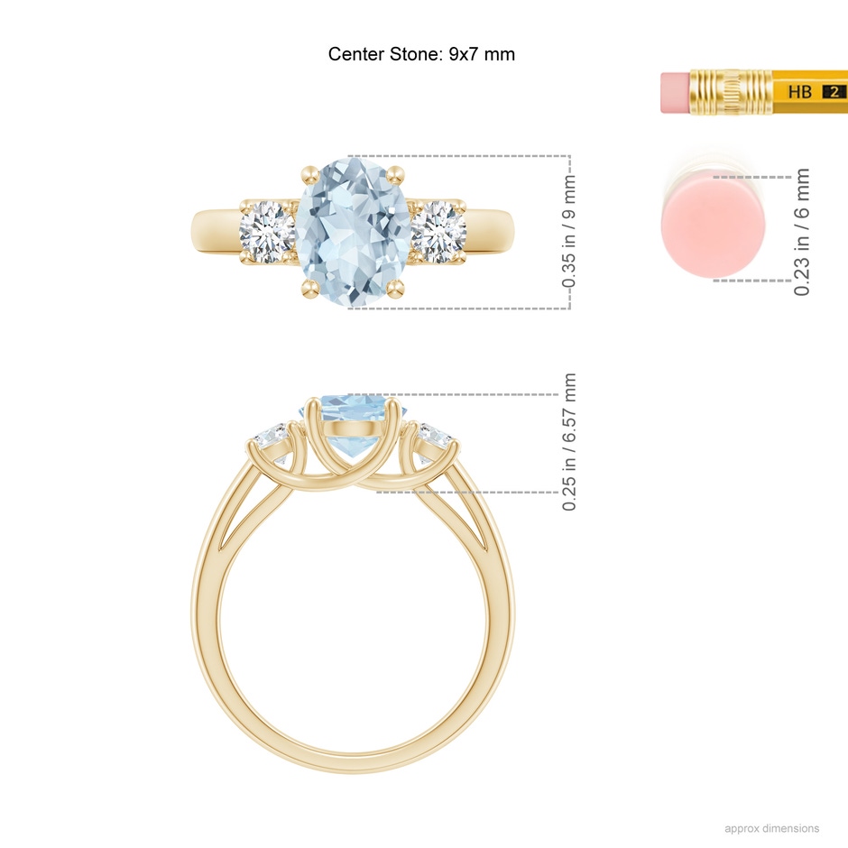 9x7mm A Oval Aquamarine and Round Diamond Three Stone Ring in Yellow Gold ruler