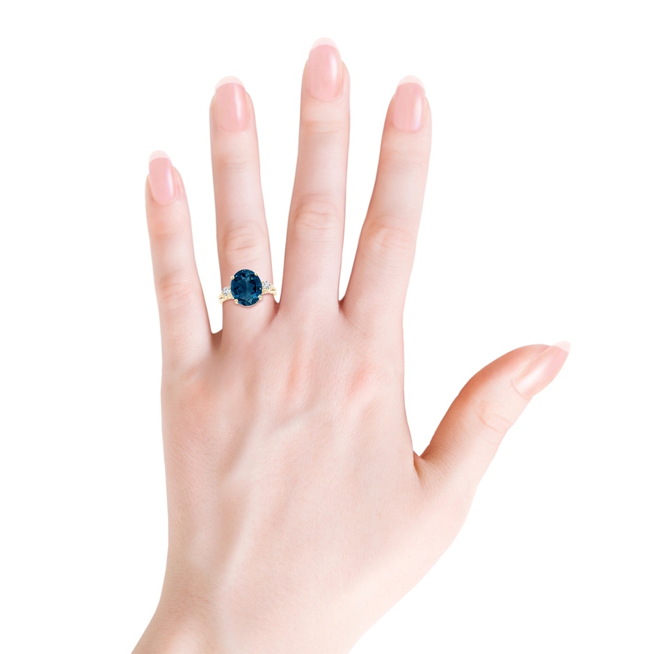 12x10mm AAAA Oval London Blue Topaz Loop Shank Ring with Diamond Accents in Yellow Gold product image