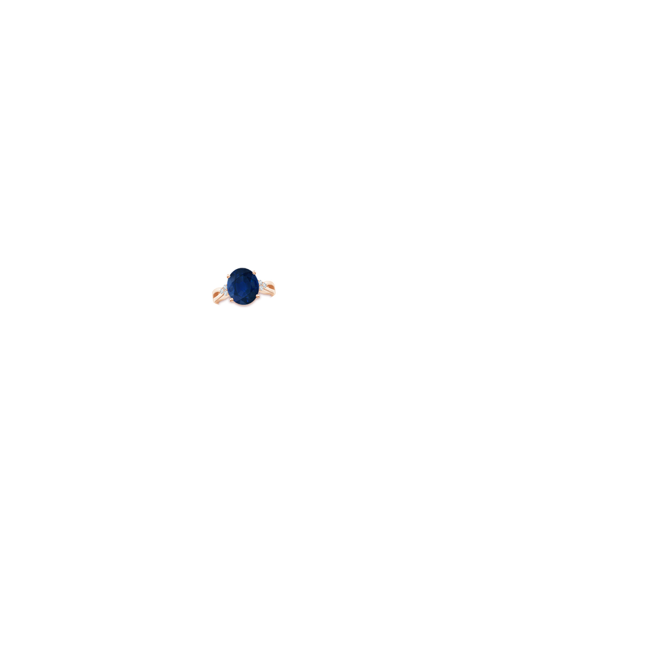 12x10mm AA Solitaire Oval Blue Sapphire Split Shank Ring with Trio Diamonds in Rose Gold hand