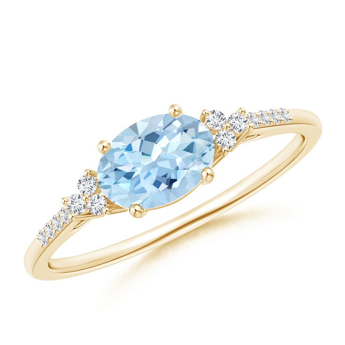 7x5mm AAA Horizontally Set Oval Aquamarine Solitaire Ring with Trio Diamond Accents in 10K Yellow Gold