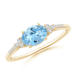 7x5mm AAAA Horizontally Set Oval Aquamarine Solitaire Ring with Trio Diamond Accents in Yellow Gold