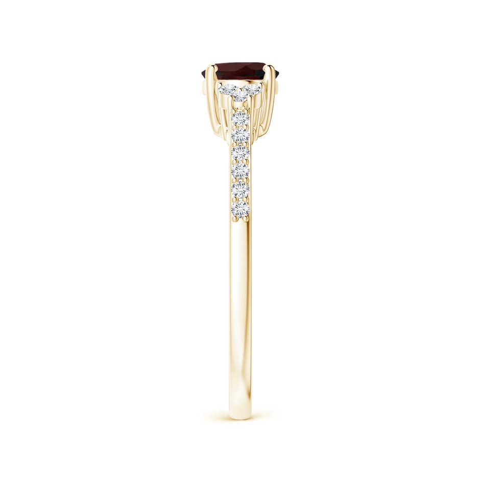 7x5mm A Horizontally Set Oval Garnet Solitaire Ring with Trio Diamond Accents in Yellow Gold side-2