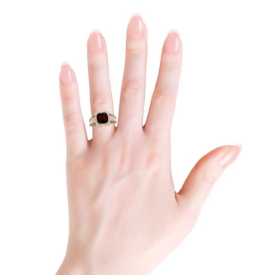 8mm A Cushion Garnet Celtic Knot Cocktail Ring in Yellow Gold body-hand