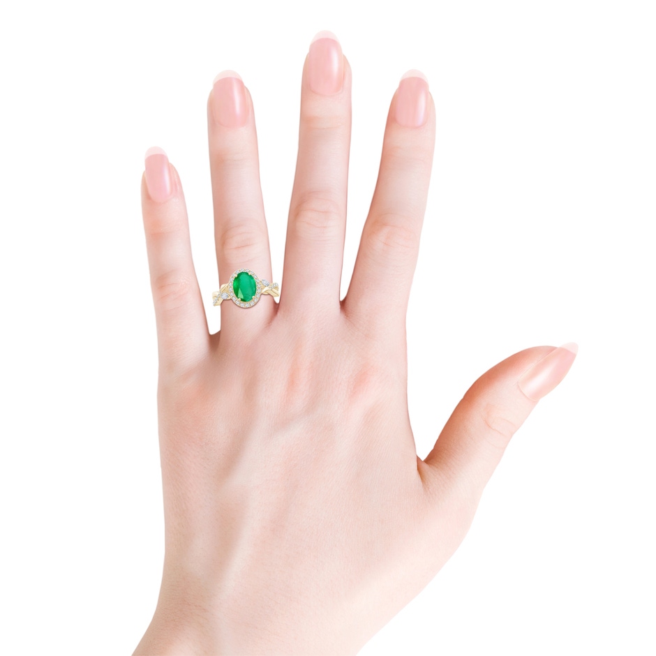 9x7mm A Oval Emerald Twisted Vine Ring with Diamond Halo in Yellow Gold body-hand