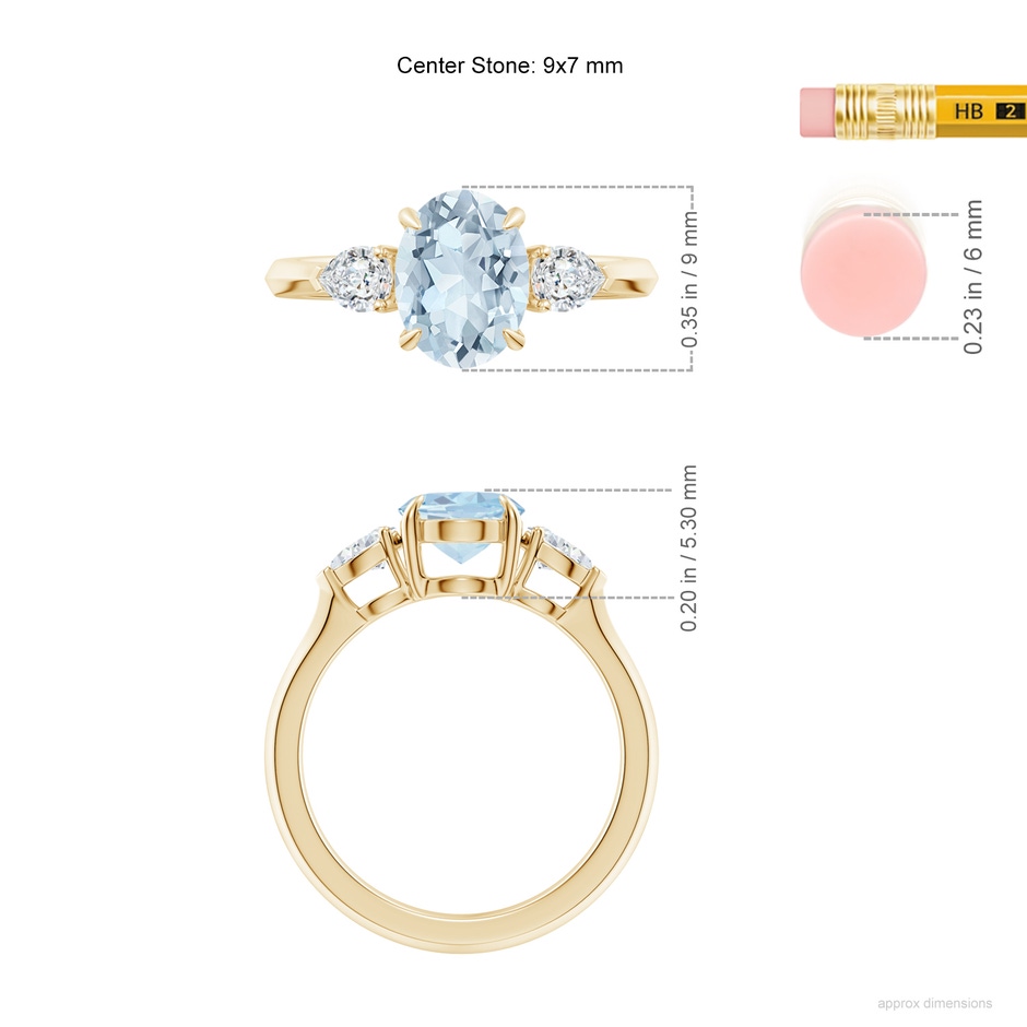 9x7mm A Oval Aquamarine and Pear Diamond Three Stone Engagement Ring in Yellow Gold ruler
